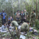 In this photo released by Colombia's Armed Forces Press Office, soldiers and Indigenous men tend to the four Indigenous brothers who were missing after a deadly plane crash, in the Solano jungle, Caqueta state, Colombia, Friday, June 9, 2023. Colombian President Gustavo Petro said Friday that authorities found alive the four children who survived a small plane crash 40 days ago and had been the subject of an intense search in the Amazon jungle. (Colombia's Armed Force Press Office via AP)